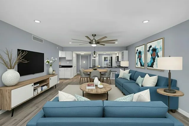 a open kitchen with granite countertop a stove top oven a sink a counter space and cabinets