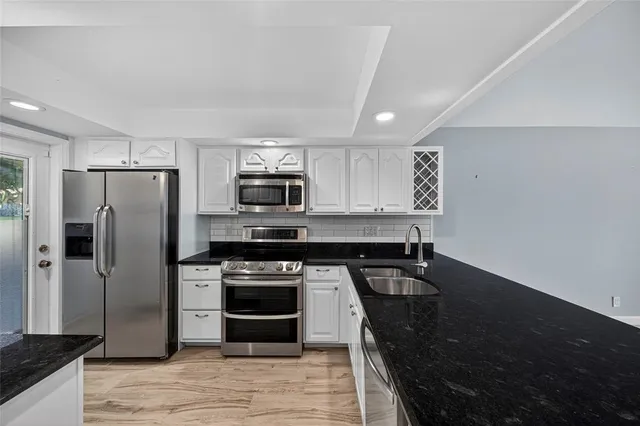 a view of a house with backyard sitting area and garden