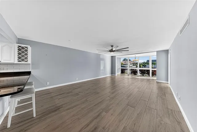 a kitchen with granite countertop a sink cabinets and stainless steel appliances