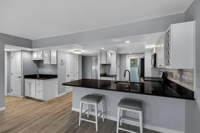a kitchen with stainless steel appliances granite countertop a stove and a microwave