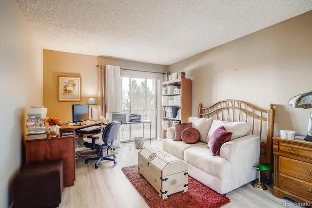 a living room with furniture a rug and a window