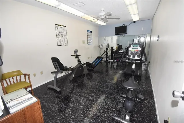 a gym room with lots of chairs and mirrors
