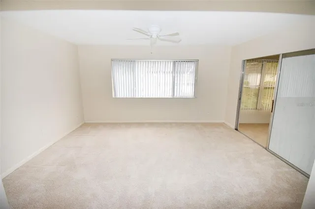 an empty room with windows and closet