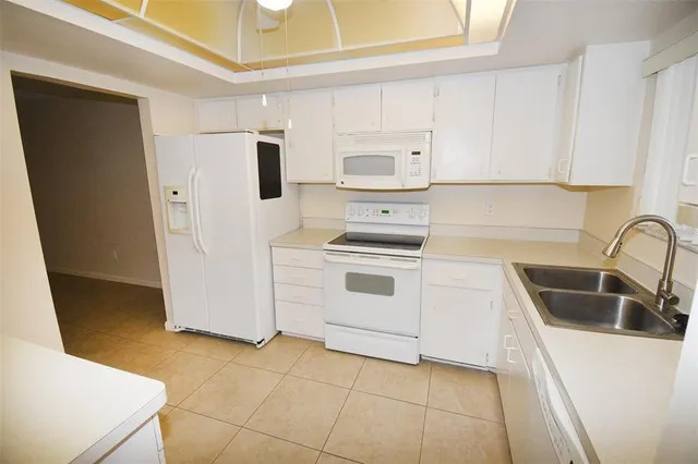 a kitchen with a sink a stove and refrigerator