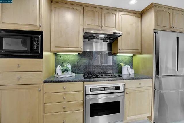a kitchen with appliances cabinets and a counter top space