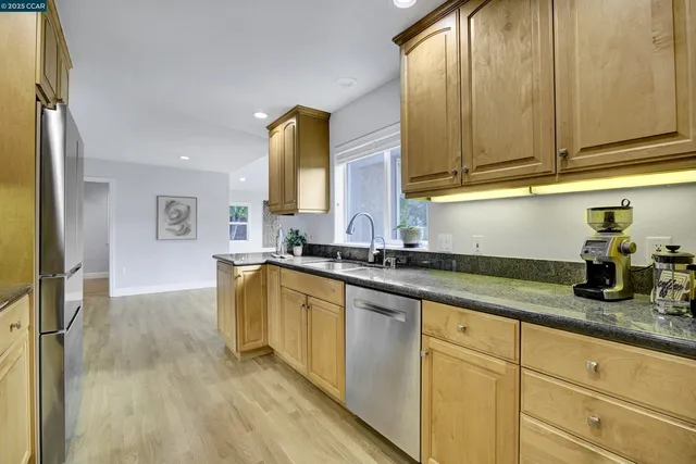 a kitchen with sink and cabinets