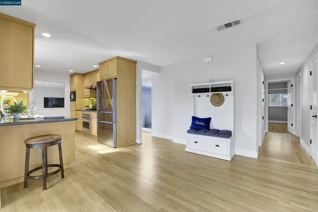 a living room with furniture and kitchen view