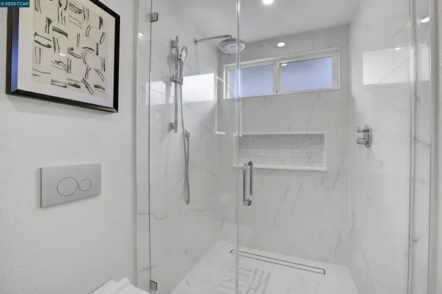 a bathroom with a shower and a glass door
