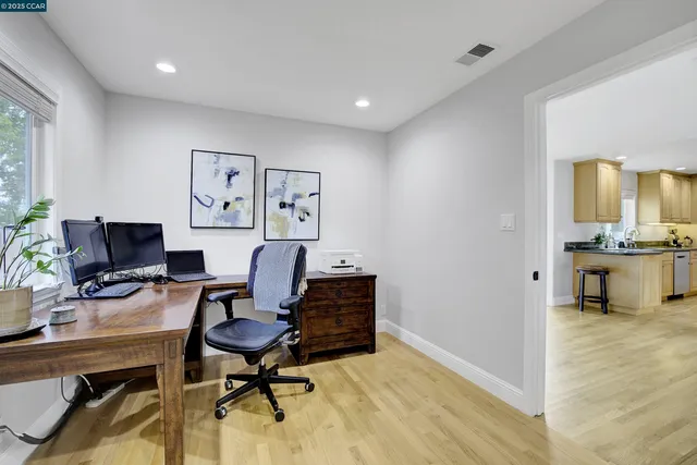 a view of a workspace with furniture and a workspace