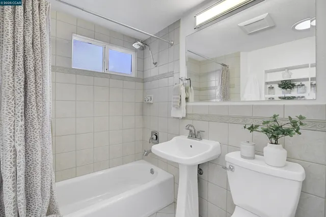 a bathroom with a sink a mirror and a bathtub