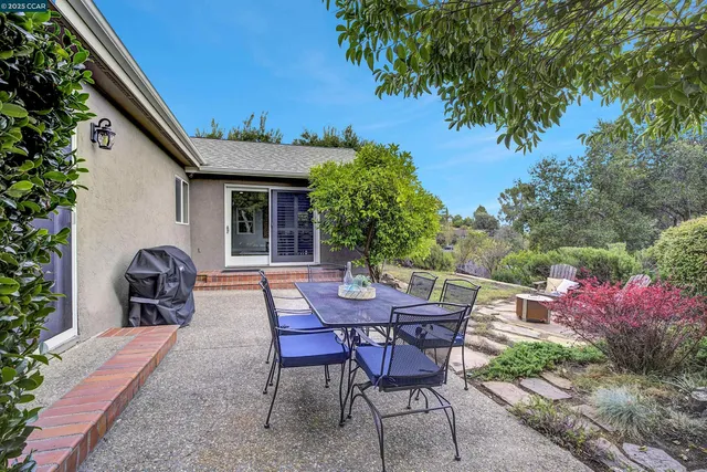 a view of a patio with table and chairs and potted plants