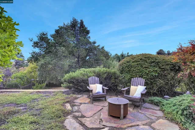 a white bench sitting in the middle of a garden