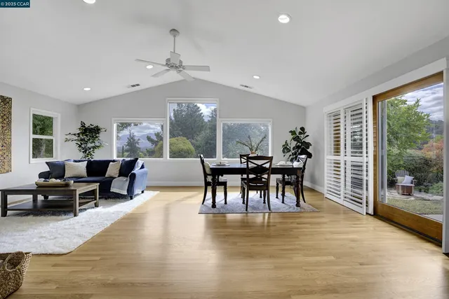 a dining room with furniture a chandelier and wooden floor