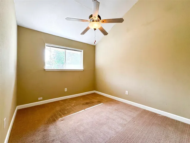 a view of room with window and ceiling fan