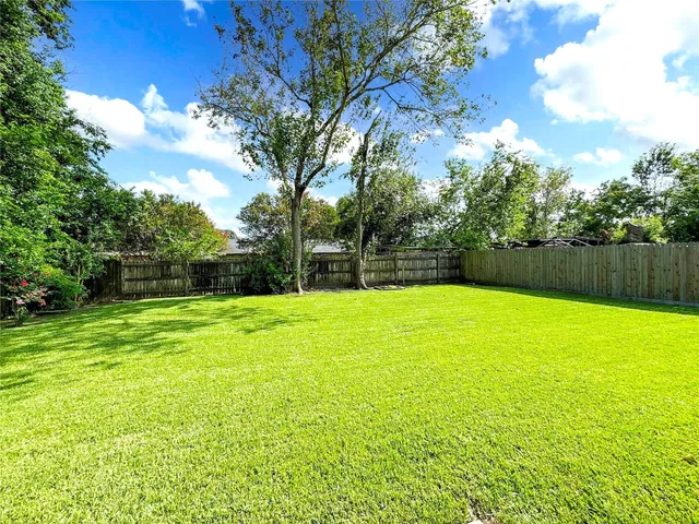 a view of a yard with a swimming pool