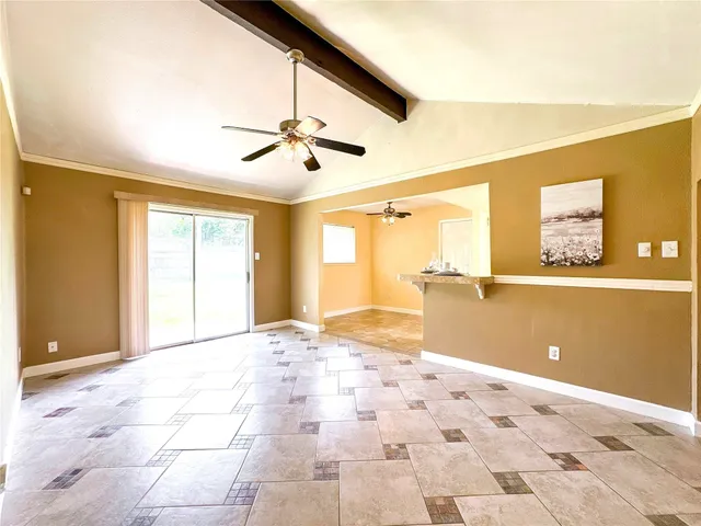 a view of a livingroom with wooden floor and a ceiling fan