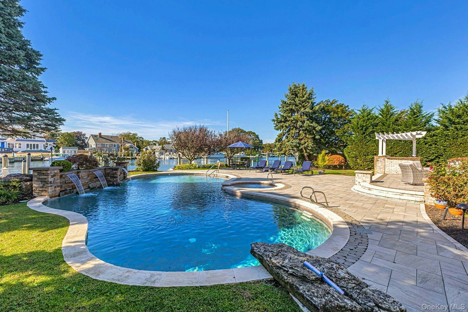 10 Beech Road Islip, NY 11751 - Photo 38 of 49 Gunite, heated, salt-water with jacuzzi and new waterfalls.