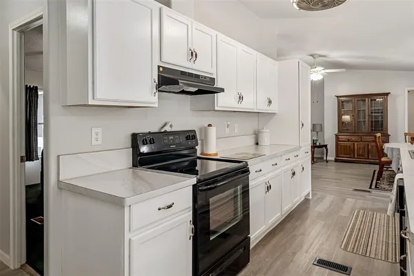 a kitchen with cabinets appliances a sink and a counter space