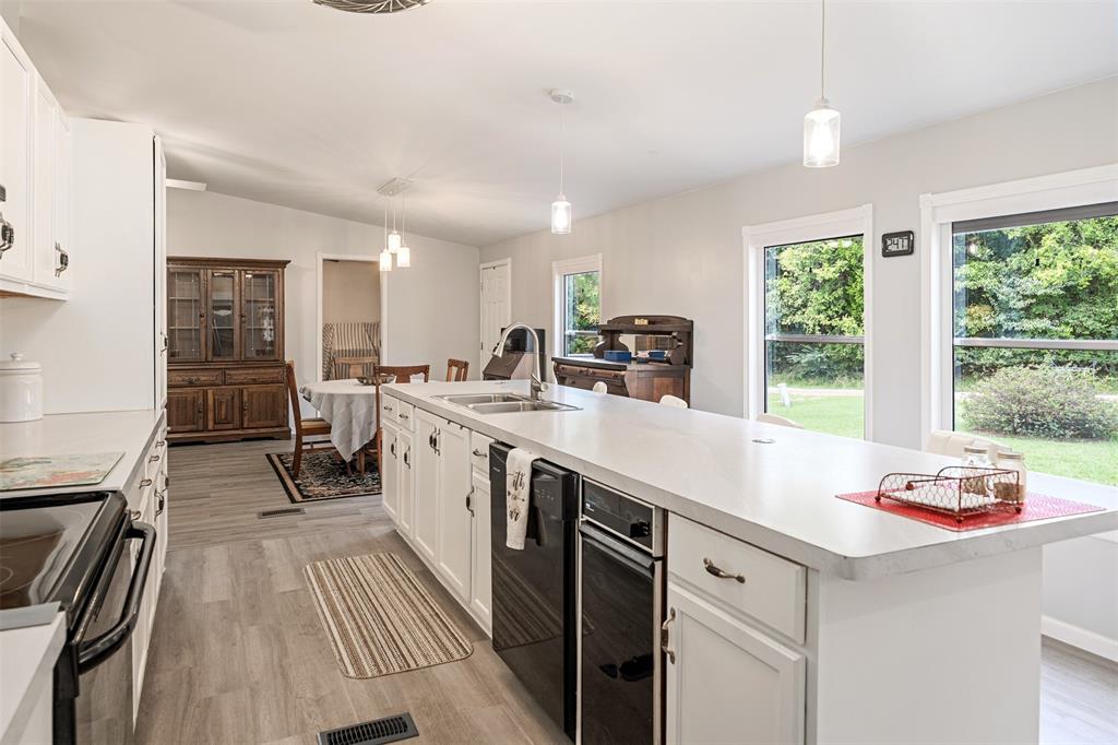 175 Kings Row Malakoff, TX 75148 - Photo 12 of 40 a kitchen with a sink stove and cabinets