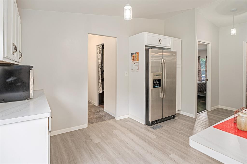 175 Kings Row Malakoff, TX 75148 - Photo 14 of 40 a view of a kitchen with refrigerator and wooden floor