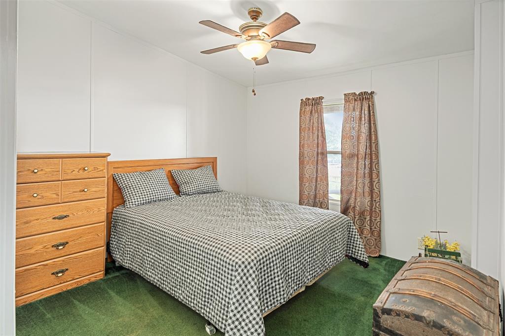 175 Kings Row Malakoff, TX 75148 - Photo 17 of 40 a bedroom with a bed and a chandelier