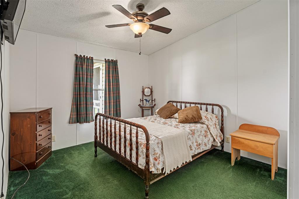 175 Kings Row Malakoff, TX 75148 - Photo 19 of 40 a bed room with a bed and a chandelier