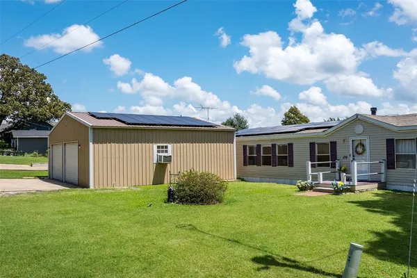 a front view of house with yard and outdoor seating
