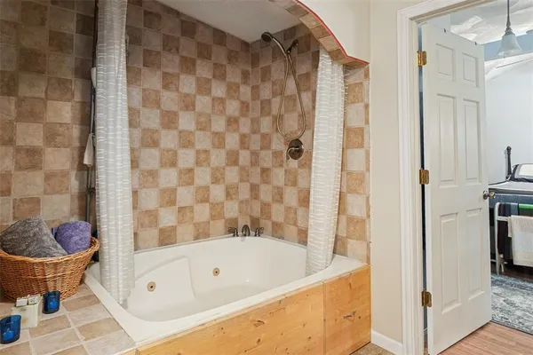 a bathroom with a bathtub and a shower