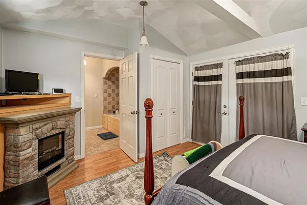 a bedroom with a bed and a fireplace