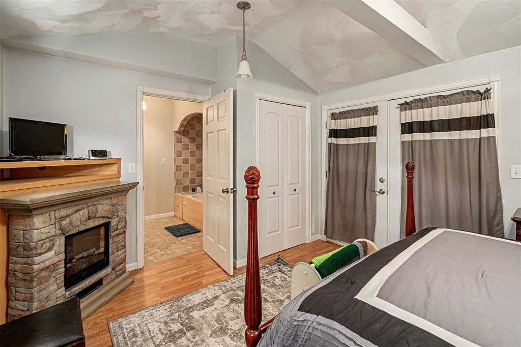 175 Kings Row Malakoff, TX 75148 - Photo 25 of 40 a bedroom with a bed and a fireplace