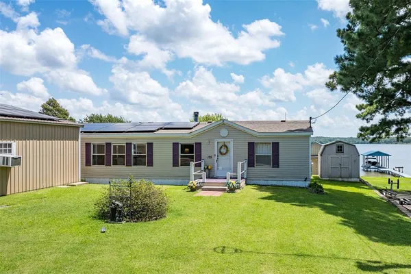 a view of a house with a backyard porch and sitting area