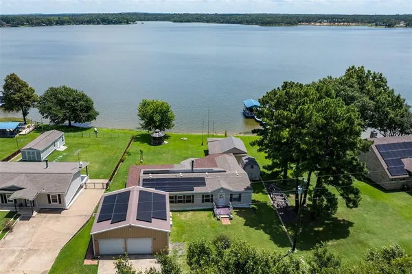 a view of a lake with couches in front of house