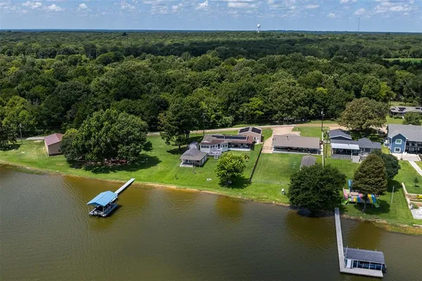 an aerial view of a house with a yard