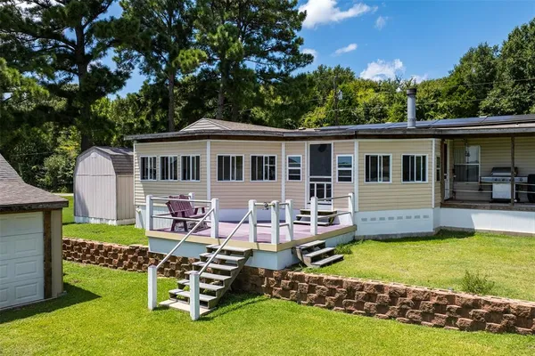 a view of a house with swimming pool and sitting area