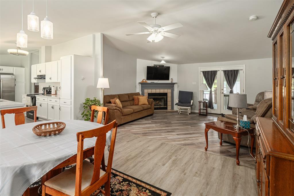 175 Kings Row Malakoff, TX 75148 - Photo 4 of 40 a living room with furniture a fireplace and a flat screen tv