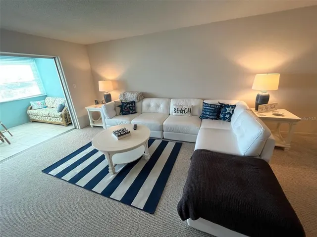 a living room with furniture and a lamp