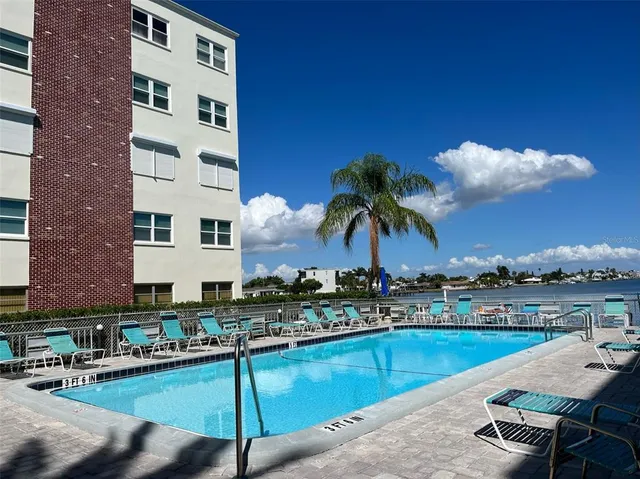 a view of a swimming pool with chairs