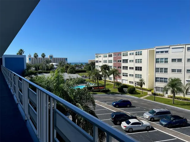 a view of a balcony with car parked