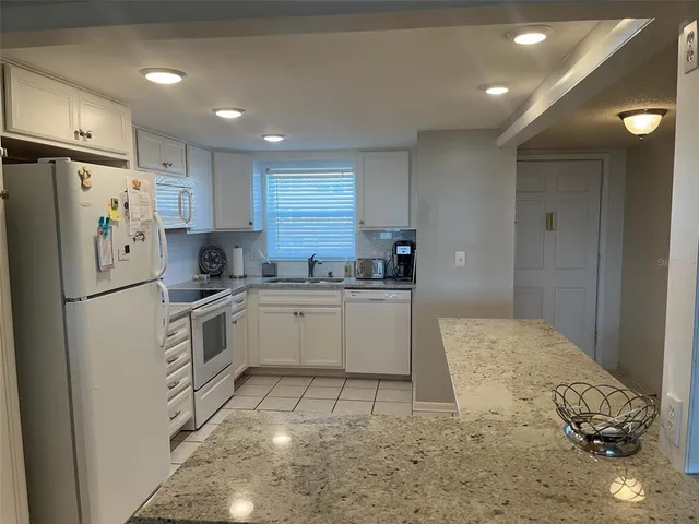 a kitchen with a refrigerator a sink and cabinets