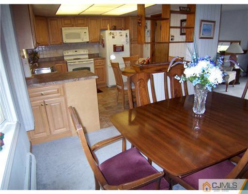 54 Oxford Road Colonia, NJ 07067 - Photo 11 of 18 a dining room with furniture and wooden floor