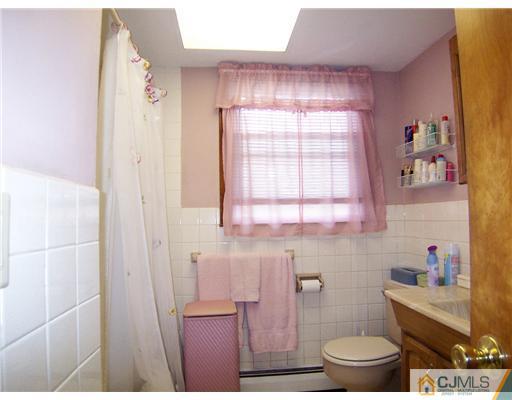 54 Oxford Road Colonia, NJ 07067 - Photo 12 of 18 a bathroom with a toilet and a shower curtain