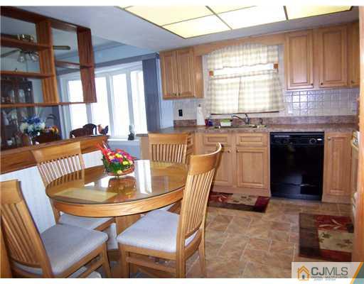 54 Oxford Road Colonia, NJ 07067 - Photo 4 of 18 a kitchen with a dining table chairs and fireplace