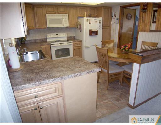 54 Oxford Road Colonia, NJ 07067 - Photo 5 of 18 a kitchen with stainless steel appliances granite countertop a sink stove and cabinets