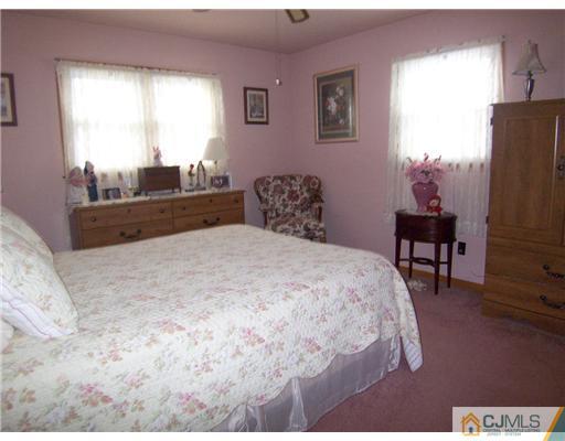 54 Oxford Road Colonia, NJ 07067 - Photo 6 of 18 a bedroom with a bed and a table