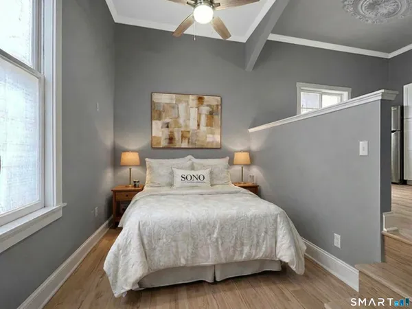 a bedroom with a bed and a window