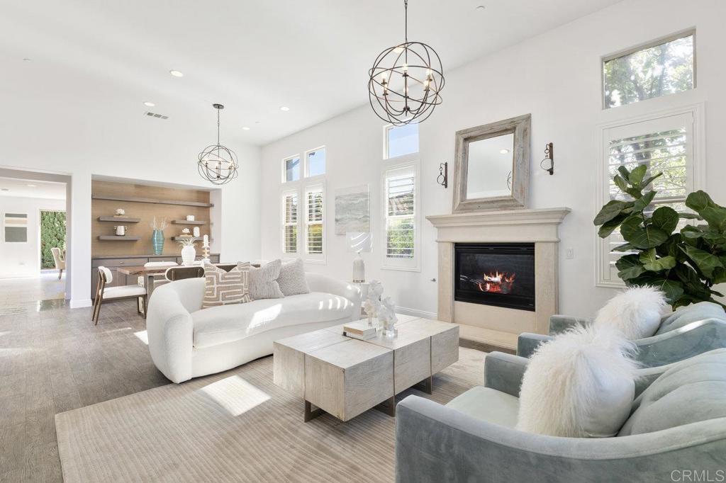 715 Blossom Road Encinitas, CA 92024 - Photo 1 of 1 a living room with furniture a fireplace and a chandelier