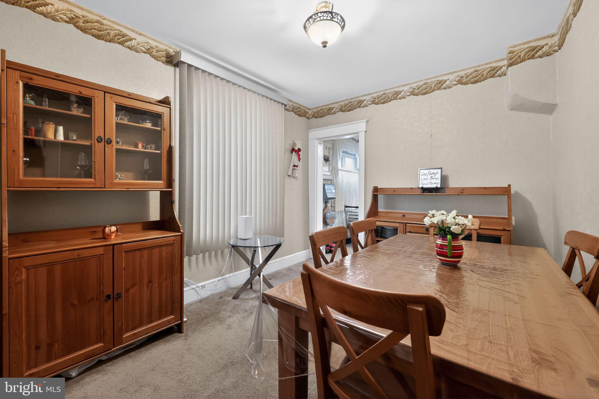 3067 Cedar Street Philadelphia, PA 19134 - Photo 11 of 30 a view of a dining room and livingroom with furniture wooden floor a rug and a chandelier