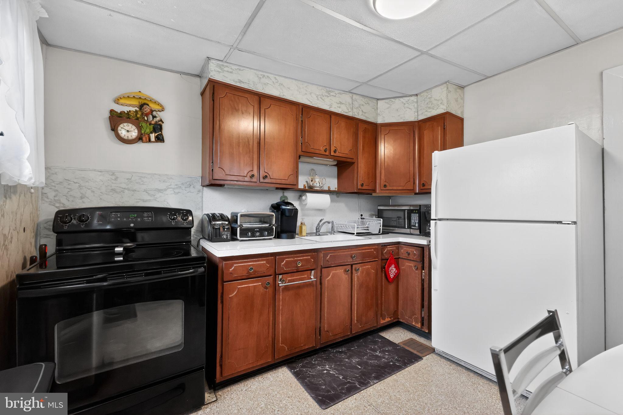 3067 Cedar Street Philadelphia, PA 19134 - Photo 14 of 30 a kitchen with stainless steel appliances granite countertop a refrigerator stove a sink and dishwasher