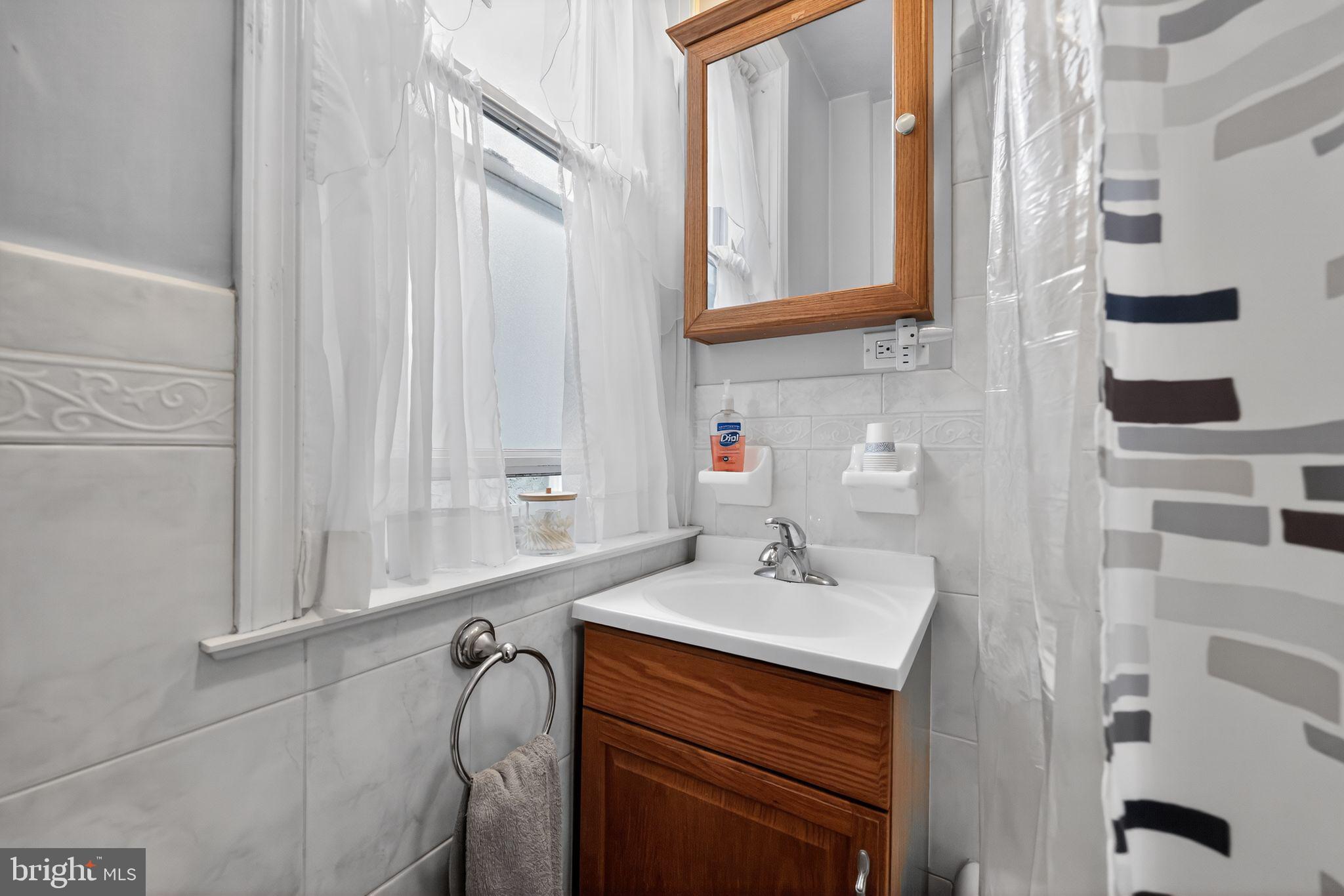 3067 Cedar Street Philadelphia, PA 19134 - Photo 18 of 30 a bathroom with a sink and a mirror