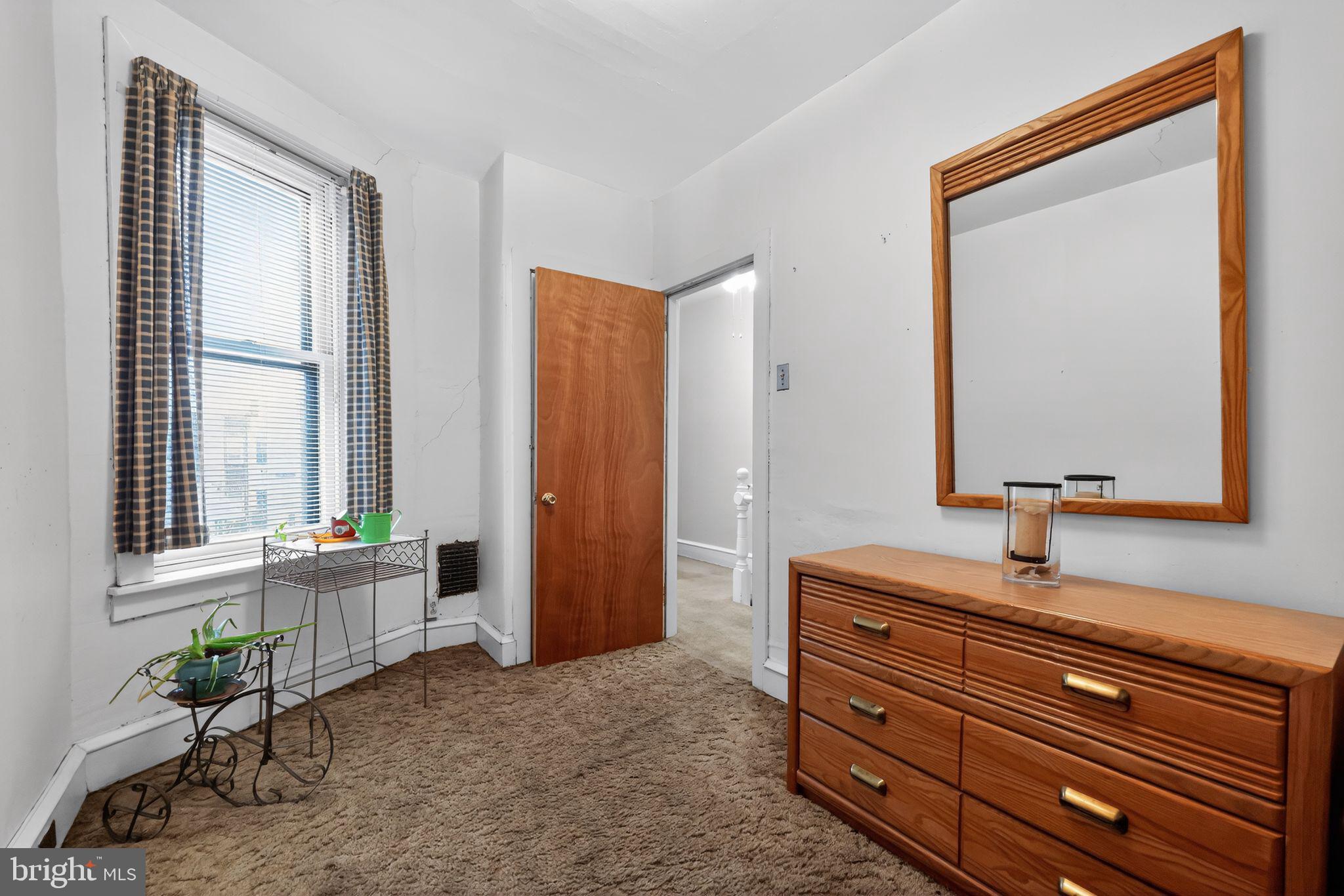 3067 Cedar Street Philadelphia, PA 19134 - Photo 23 of 30 a room with a bed and a mirror